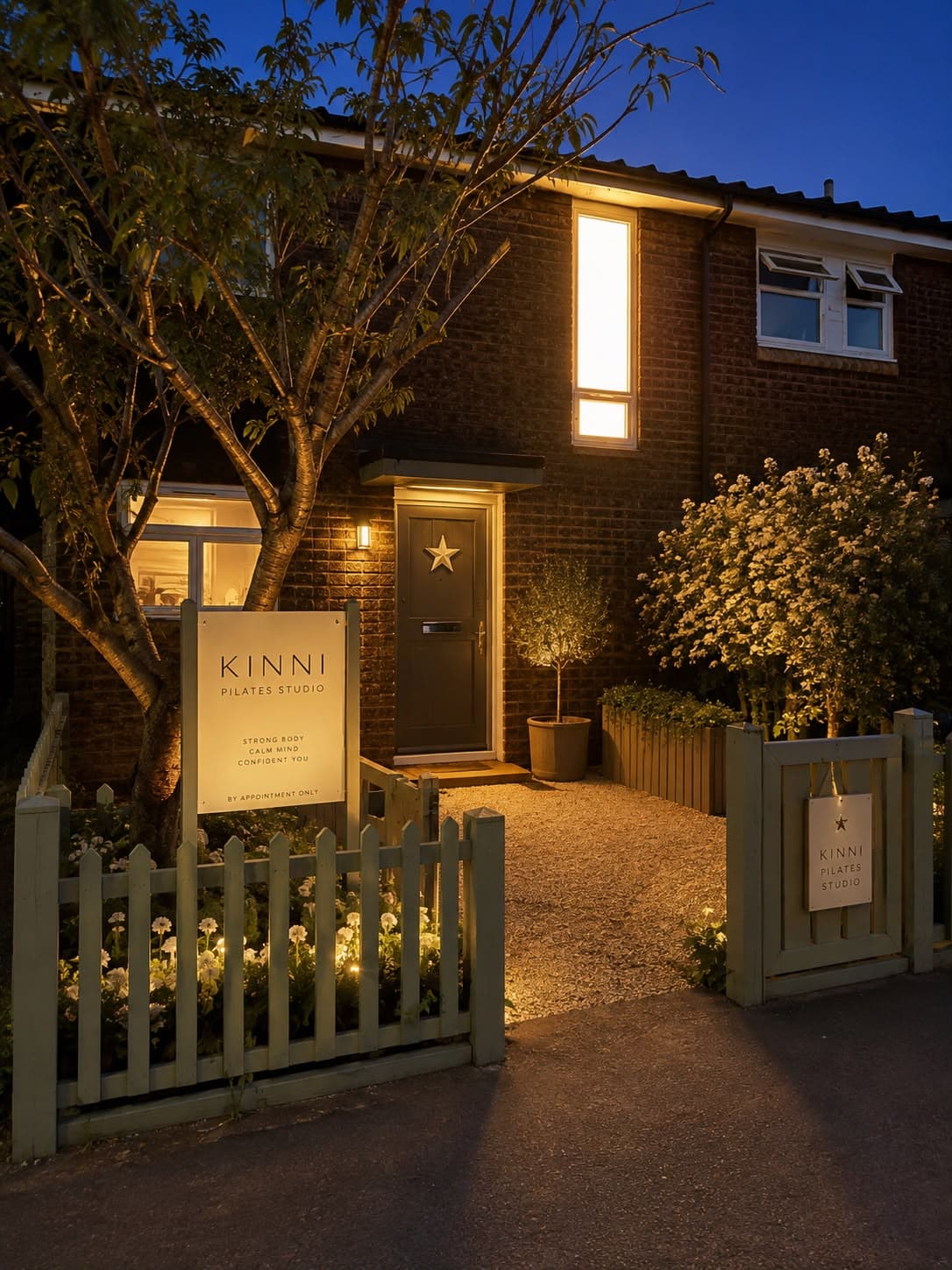 The Kinni Reformer Pilates entrance, lit at dusk